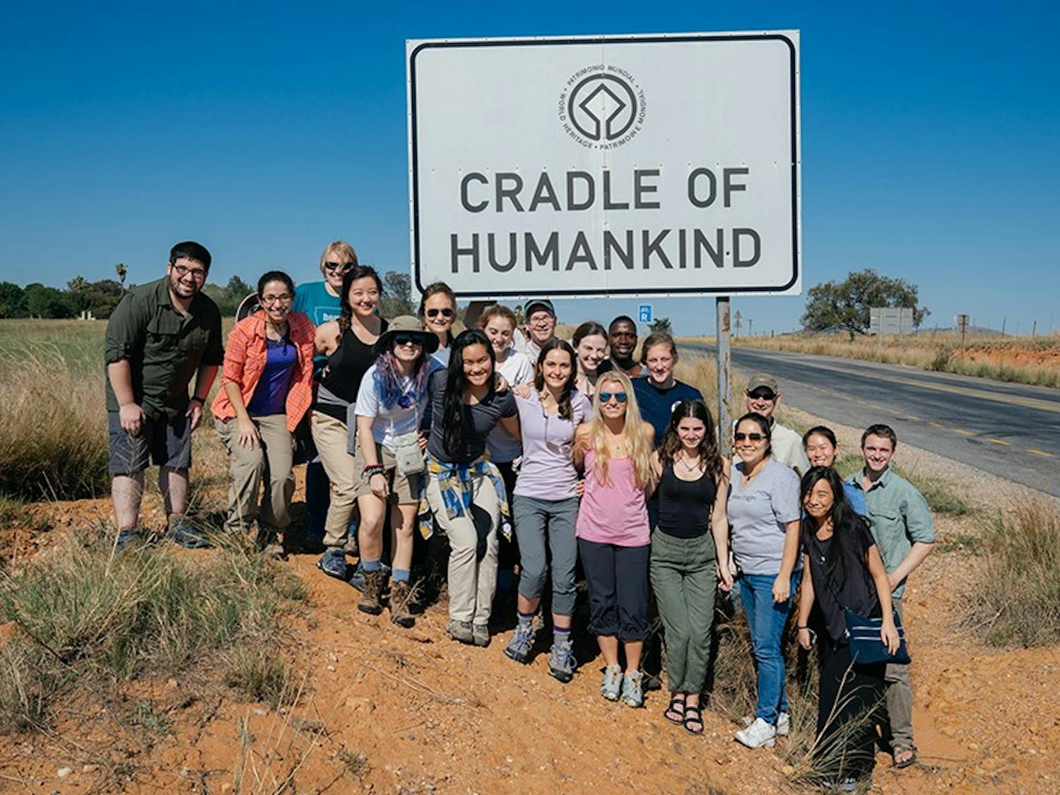 The class poses at the entrance to the Cradle of Humankind World Heritage Site, a region famous for the many hominid species discovered there. During their week at the Cradle of Humankind, the students visited several archaeological sites and worked on a dig.

Front row: Adam Nemeroff, an instructional designer who traveled with the class; Jessica Kittleberger ’18; Kathy Li ’17; Keira Byno ’19; Elizabeth T. K. (Kalei) Akau ’18; Katherine Clayton ’18; Lauren Gruffi ’17; Olivia Wiener ’19; Cindy Ramirez ’18; Saemi Han ’18. Back row: Ellison McNutt GR; Jacqueline Saralegui ‘18; Julia Cohen ‘18; Jeremy DeSilva, one of the professors leading the class; Sarah Miller ‘19; Eric (??? Driver); Abigail Reynolds ‘17; Nathaniel Dominy, a professor who led the class with DeSilva; Erica Ng ’19; Michael Everett ‘19., South Africa, Anthropology 70