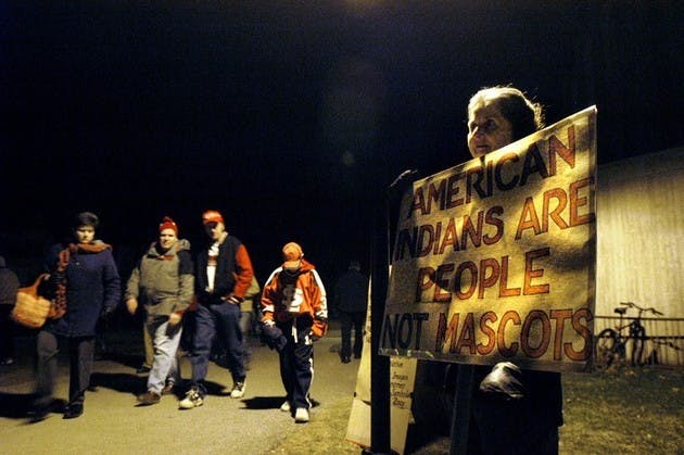 Shelby Grantham, an English professor at the College, protested the University of North Dakota's Fighting Sioux logo outside Thompson Arena on Dec. 29. UND beat the Big Green, 4-1.