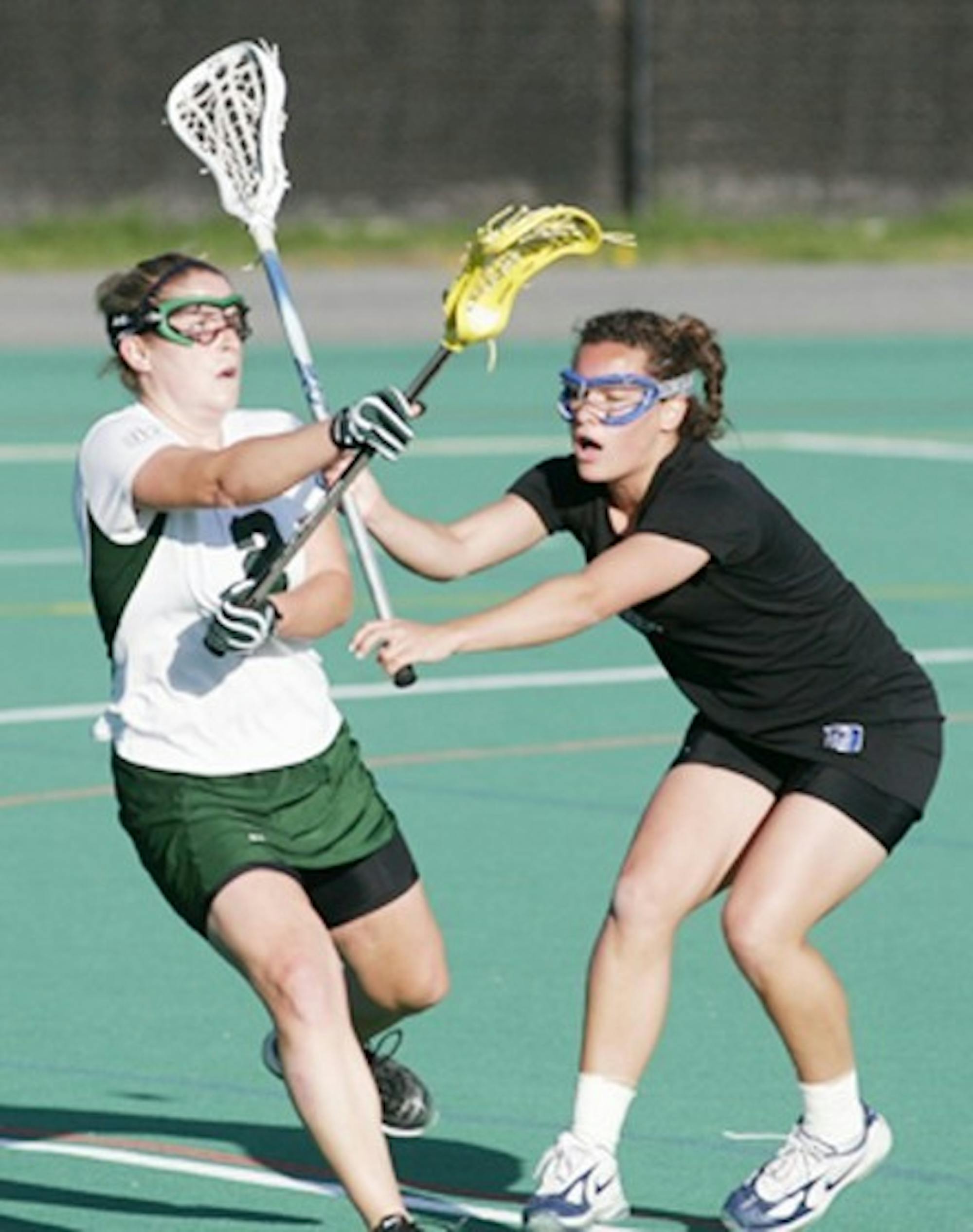 Co-captain Kristen Zimmer '06 passes the ball against Duke this spring. Dartmouth lost to Duke but made it all the way to the national finals.