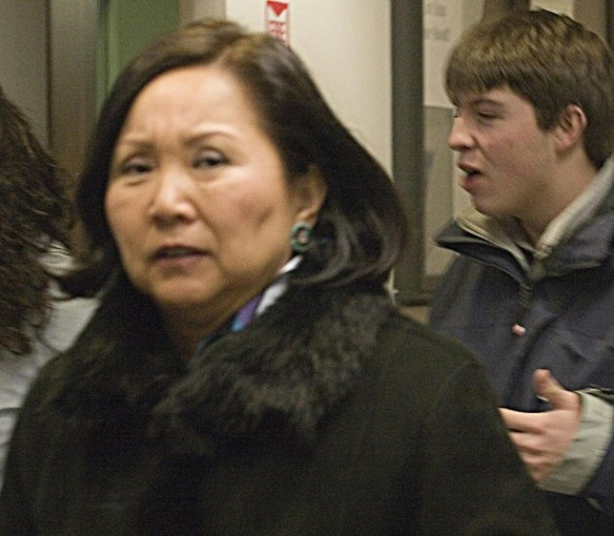 Jean Kim, one of the finalists for the Dean of the College position, hurries past a photographer on her way into a Palaeopitus meeting on Wednesday.
