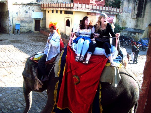 Meg Leddy-Cecere '12 and Mia Jessup '12 experience a local form of transportation while studying abroad in Hyderabad, India.