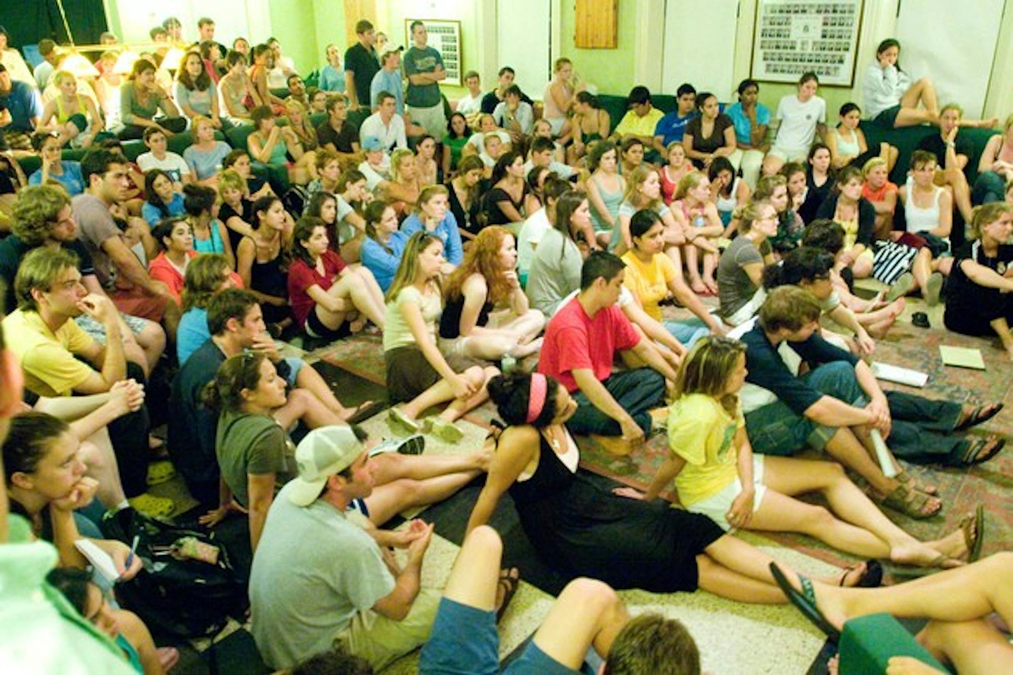 Students crowd Gamma Delta Chi fraternity's chapter room Tuesday to discuss gender issues on campus.