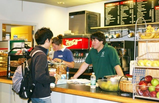 Julio Gil '08 and Anne Kennedy '07 serving Edward Son '08 at Novack Cafe. Student employees have received mixed reviews from full-time staff.