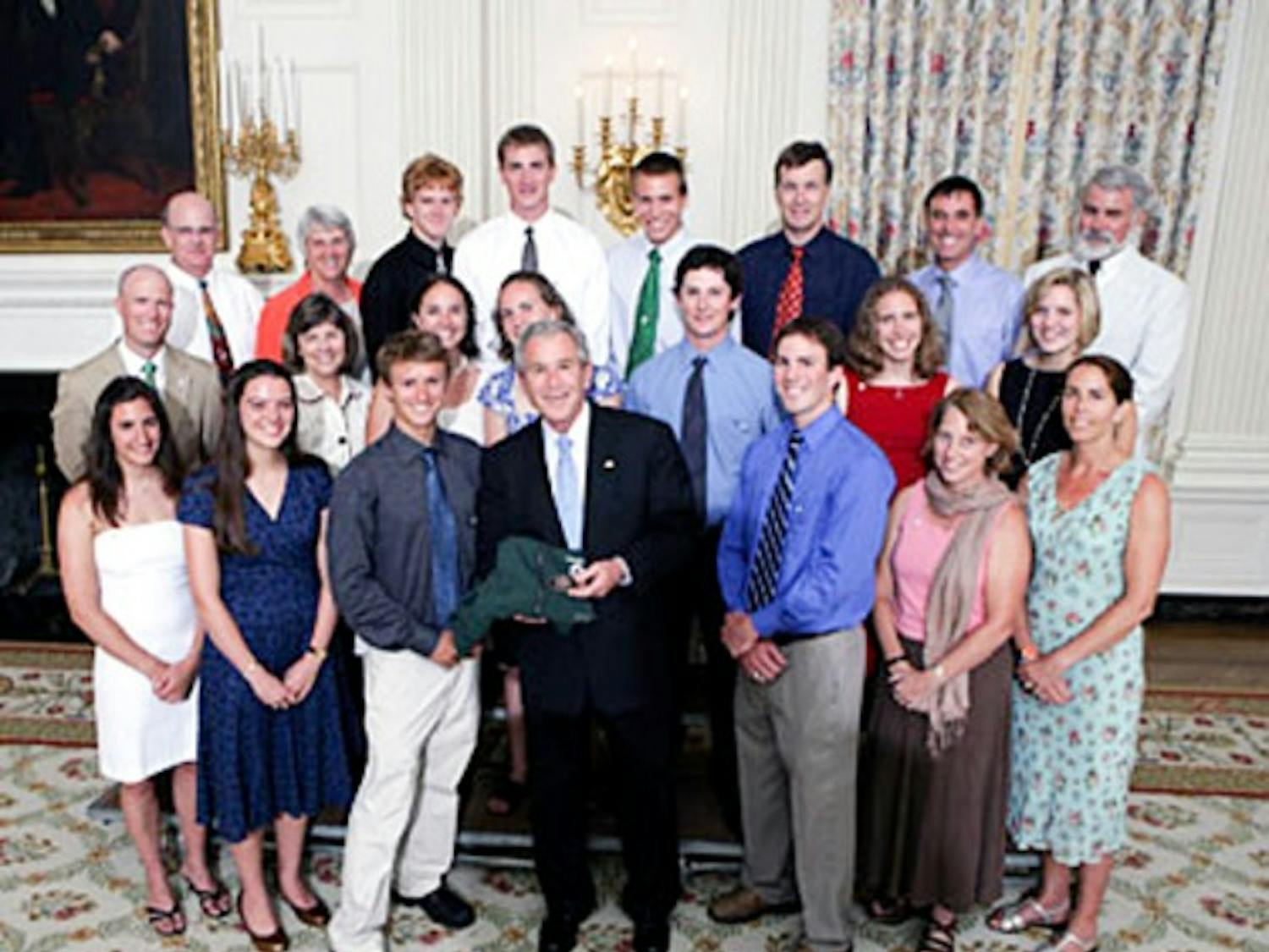 The Dartmouth ski team poses and presents a gift to President George W. Bush during Champions' Day at the White House on Monday.