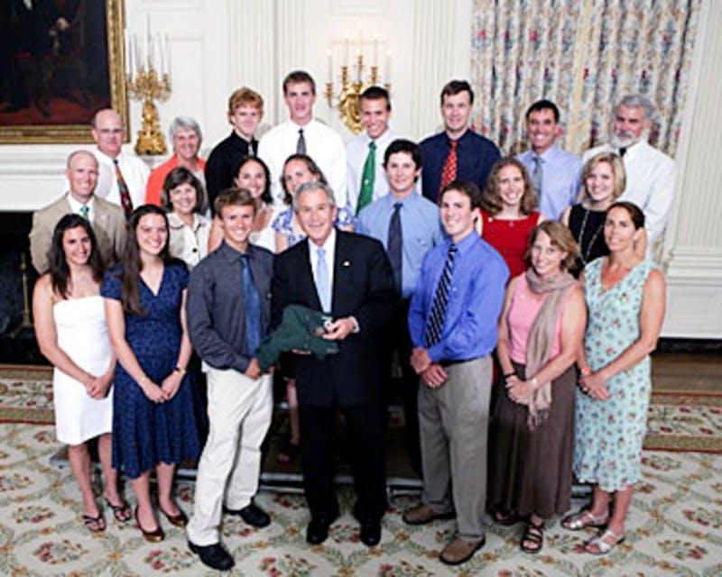 The Dartmouth ski team poses and presents a gift to President George W. Bush during Champions' Day at the White House on Monday.