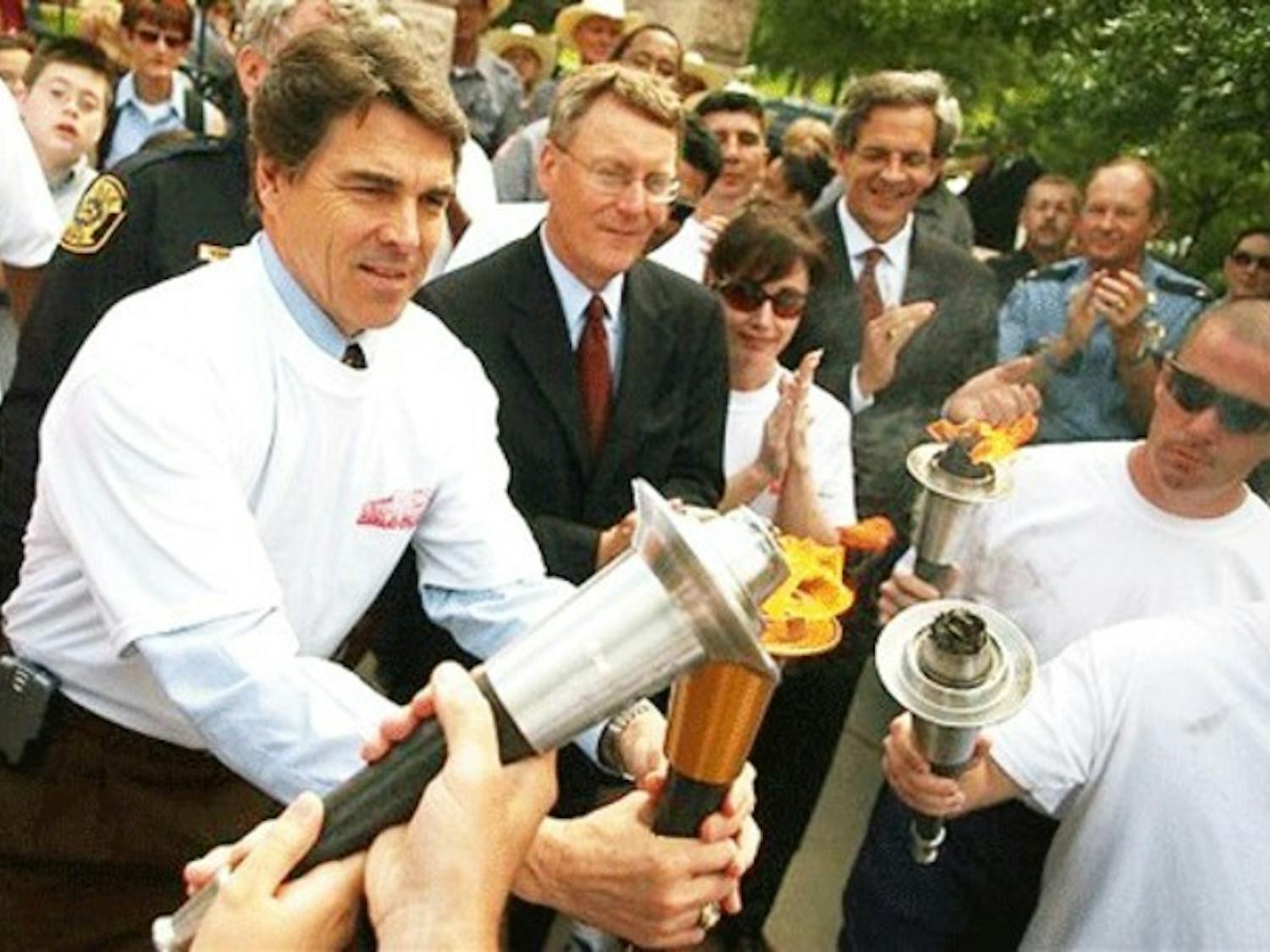 Texas Gov. Rick Perry lights a torch outside the Capitol on Monday to kick off the 2006 Special Olympics, a nationwide event coming to the Upper Valley.
