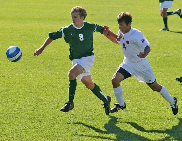 Craig Henderson '09 eludes his man and takes the ball; Henderson contributed to the Big Green's tourney win.
