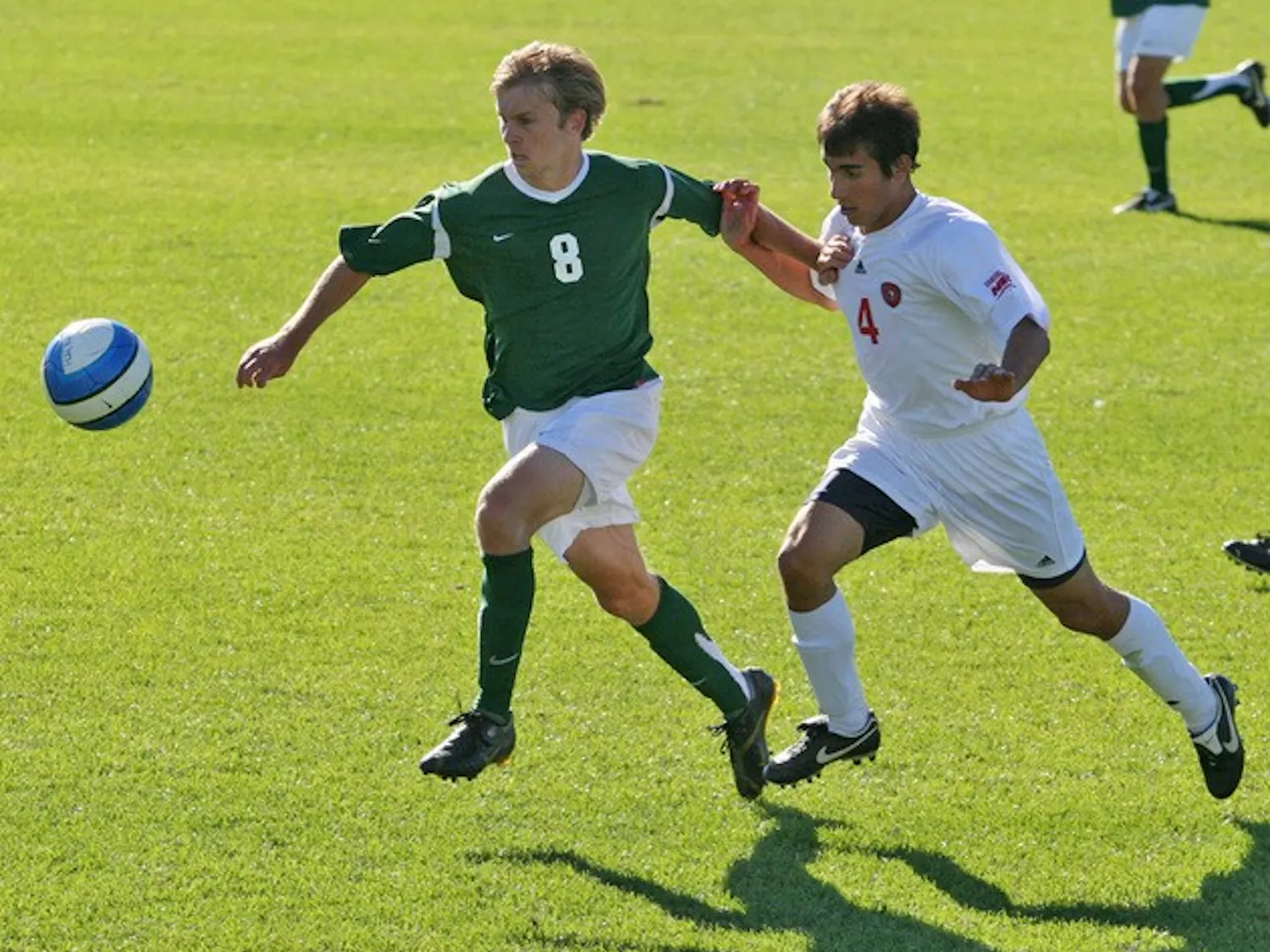 Craig Henderson '09 eludes his man and takes the ball; Henderson contributed to the Big Green's tourney win.