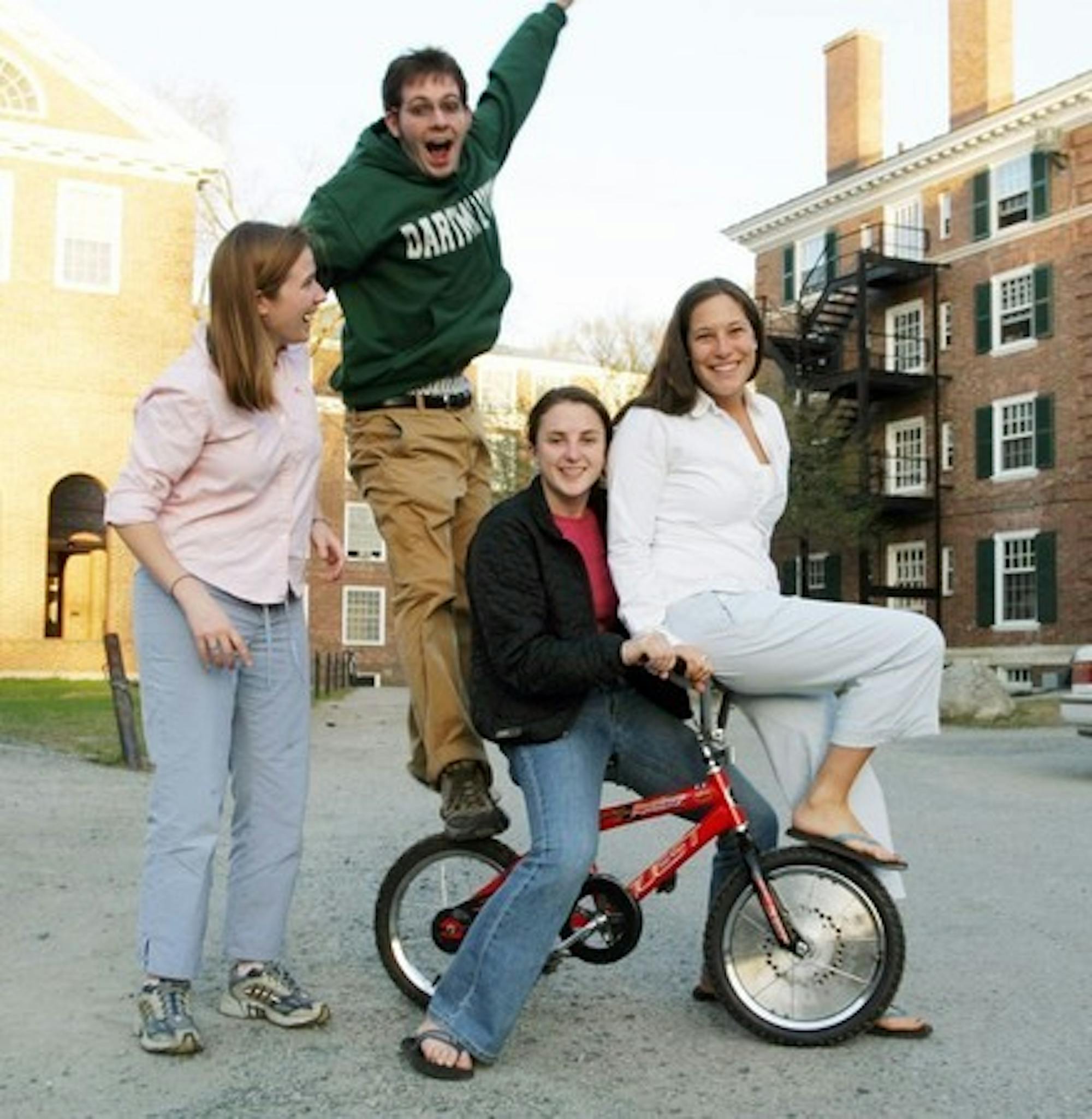 Augusta Niles '07, Nathan Sigworth '07, Deborah Sperling '06 and Hannah Murnen '06 stand with the Gyrobike, their Engineering 21 team project.