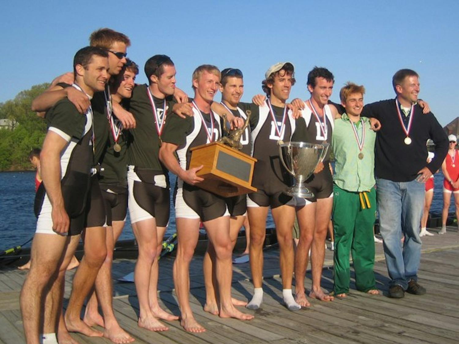 Big Green lightweight crew posing with both their Ivy League and Eastern Sprints Championship trophies.