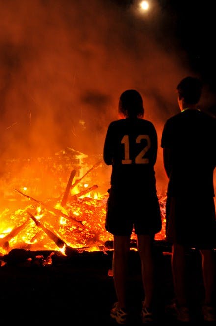 Students admire the smoldering remnants of the Homecoming bonfire on Friday night.