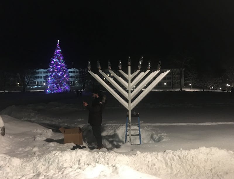 Rabbi Moshe Leib Gray lights the menorah on Thursday evening to commemorate the last night of Hanukkah.