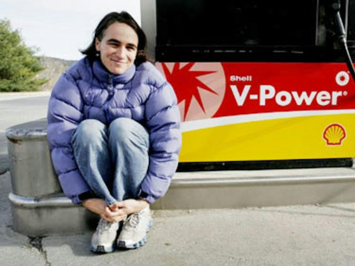 Cindy Pierce of Etna, N.H., poses for a photograph at a Lebanon, N.H., gas station on November 19, 2005. Pierce has been using her "V-Power" as fuel for her one-woman show, "Finding the Doorbell." (Geoff Hansen photograph)