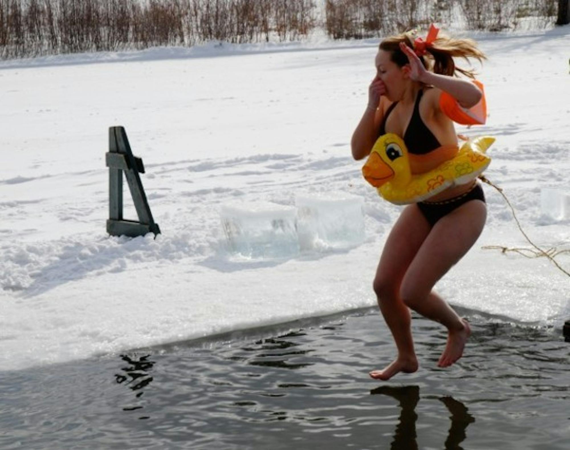 A student and her inflatable duck take part in Saturday's polar bear swim.