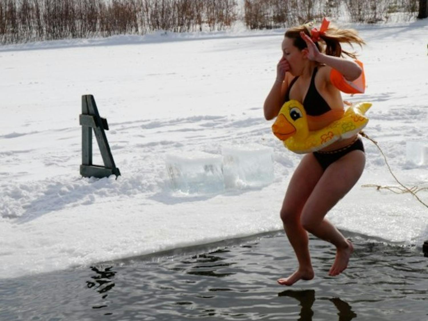 A student and her inflatable duck take part in Saturday's polar bear swim.