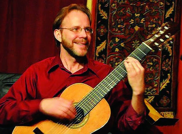 Dartmouth professor David Newsam, on guitar, performed with vocalist Jenni Cook and other musicians in Rollins Chapel this weekend.