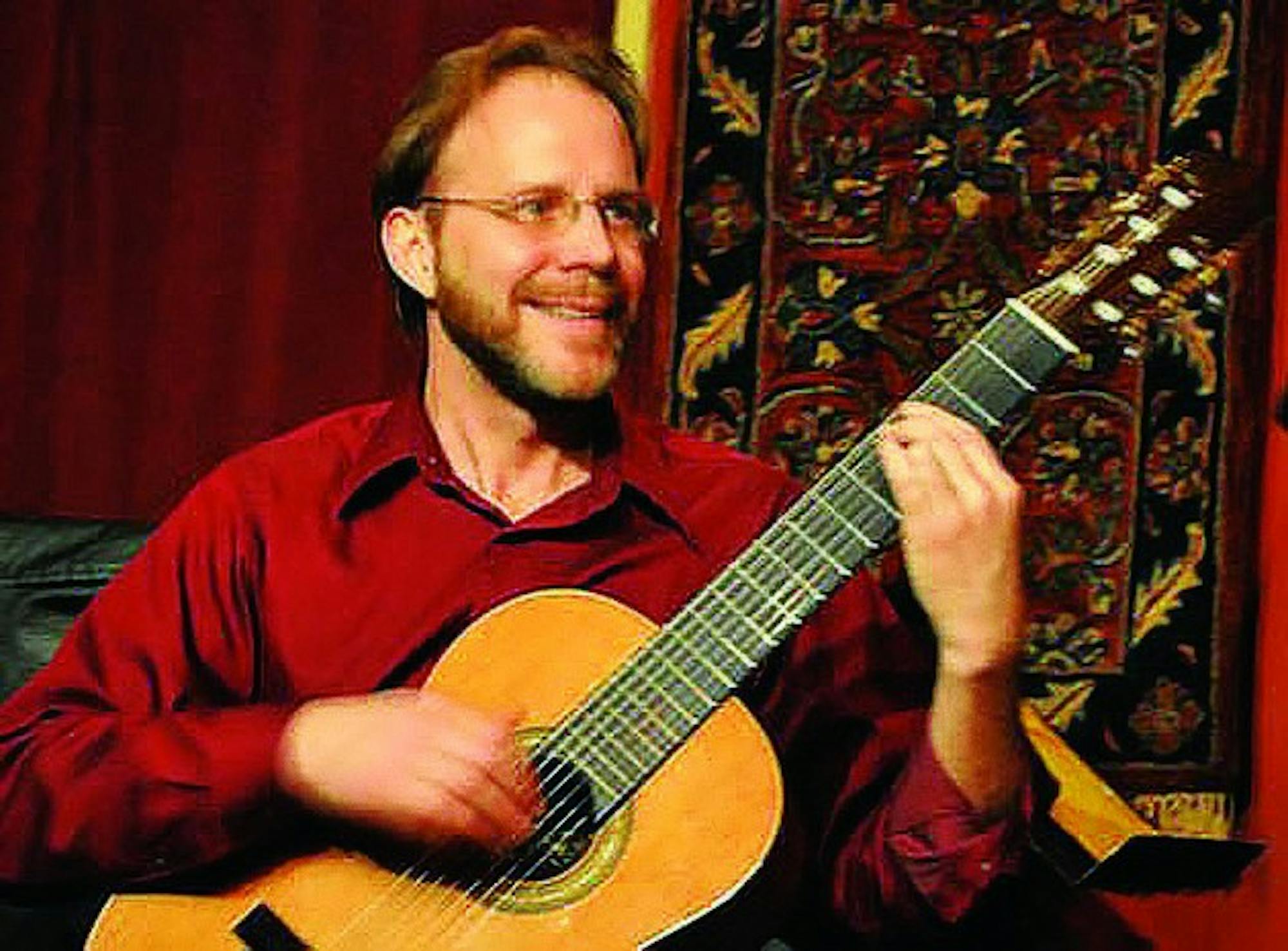 Dartmouth professor David Newsam, on guitar, performed with vocalist Jenni Cook and other musicians in Rollins Chapel this weekend.
