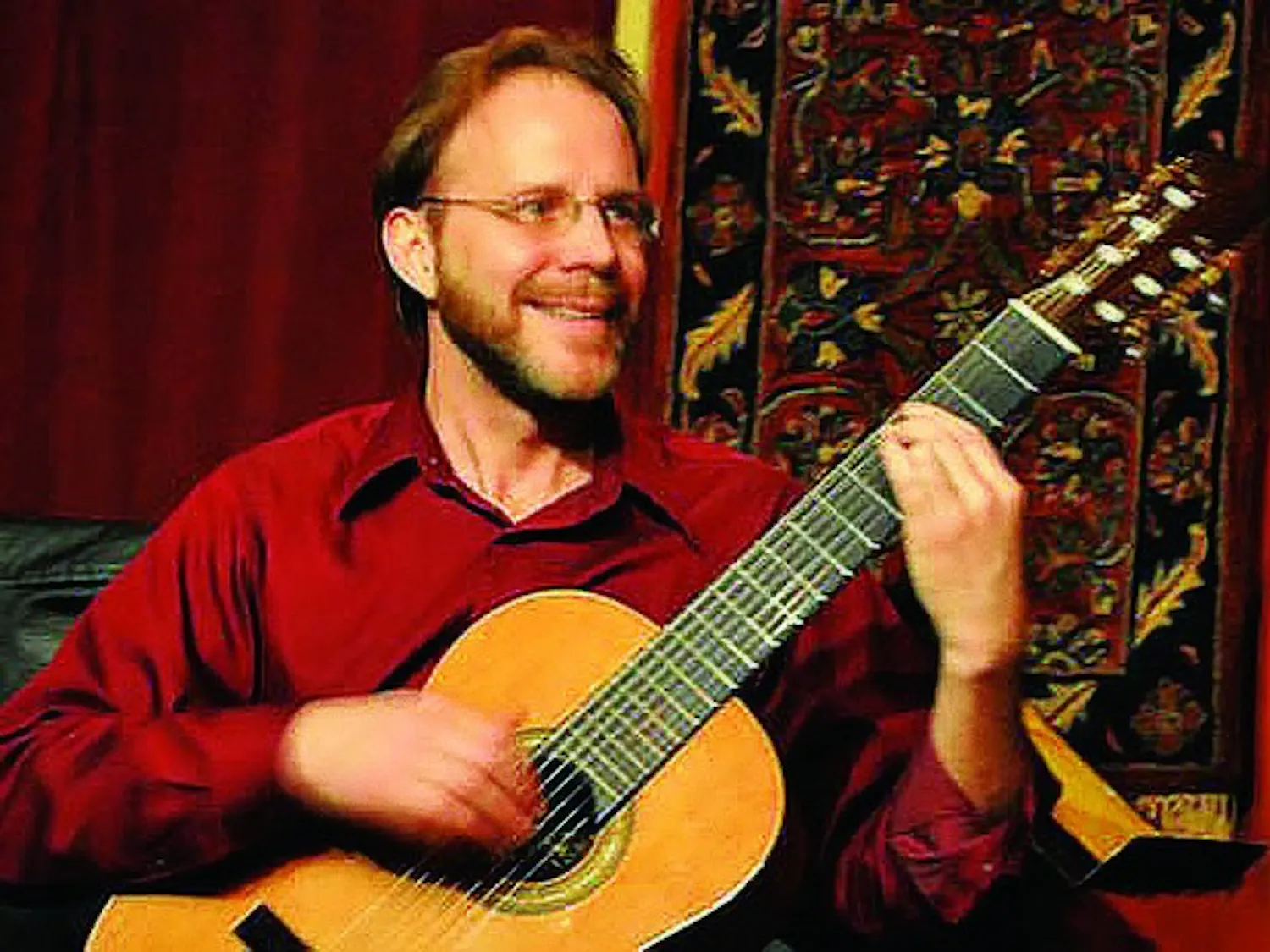 Dartmouth professor David Newsam, on guitar, performed with vocalist Jenni Cook and other musicians in Rollins Chapel this weekend.