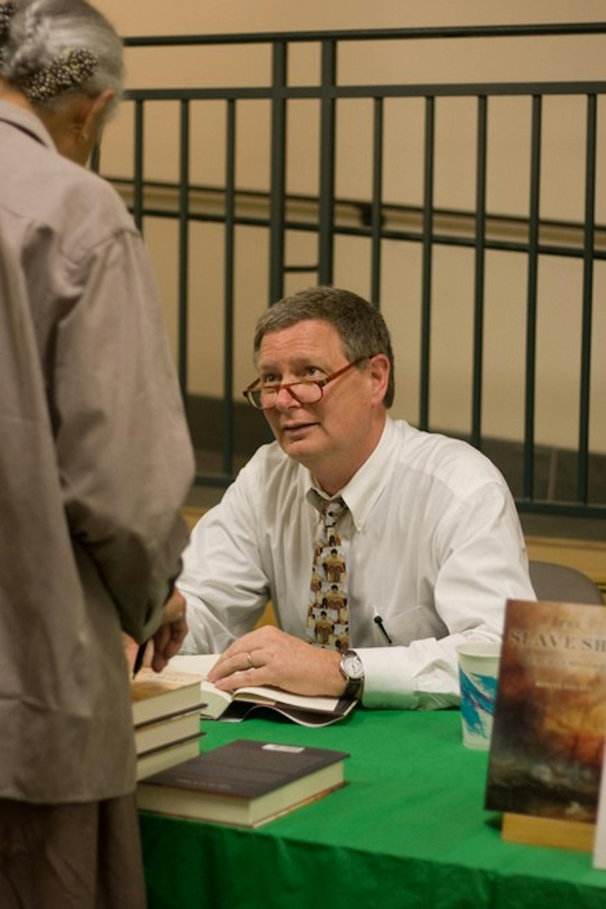 Professor Marcus Rediker signs copies of his book, 