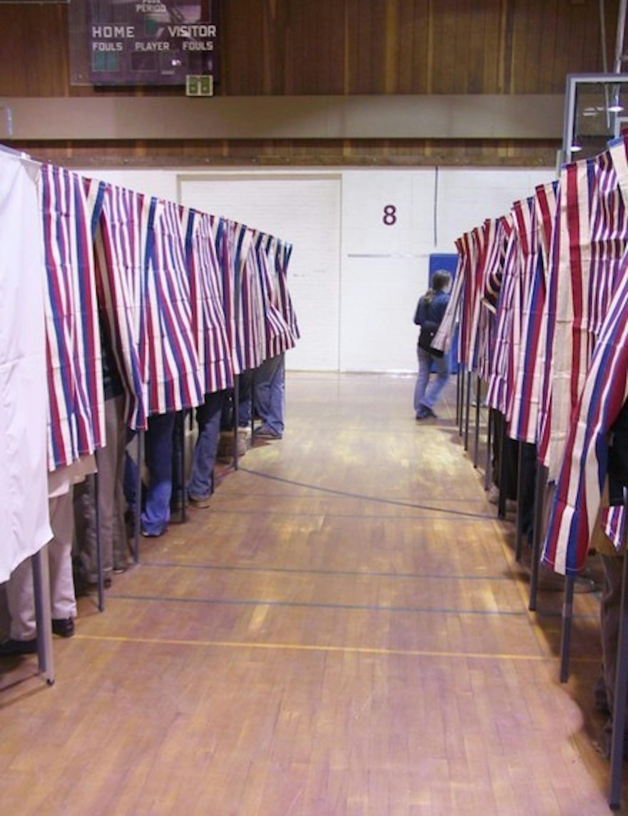 Citizens vote in the 2004 national election at the local polls at Hanover High School. The polling place has moved to Richmond Middle School this year.