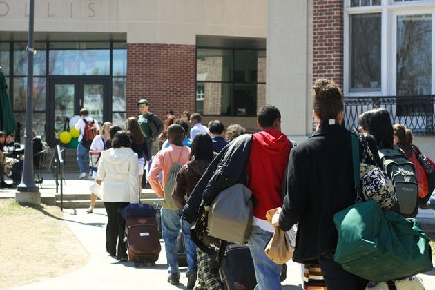 large group arrival (right off the bus) of prospective students walk to collis to check in and be placed with their hosts for the weekend