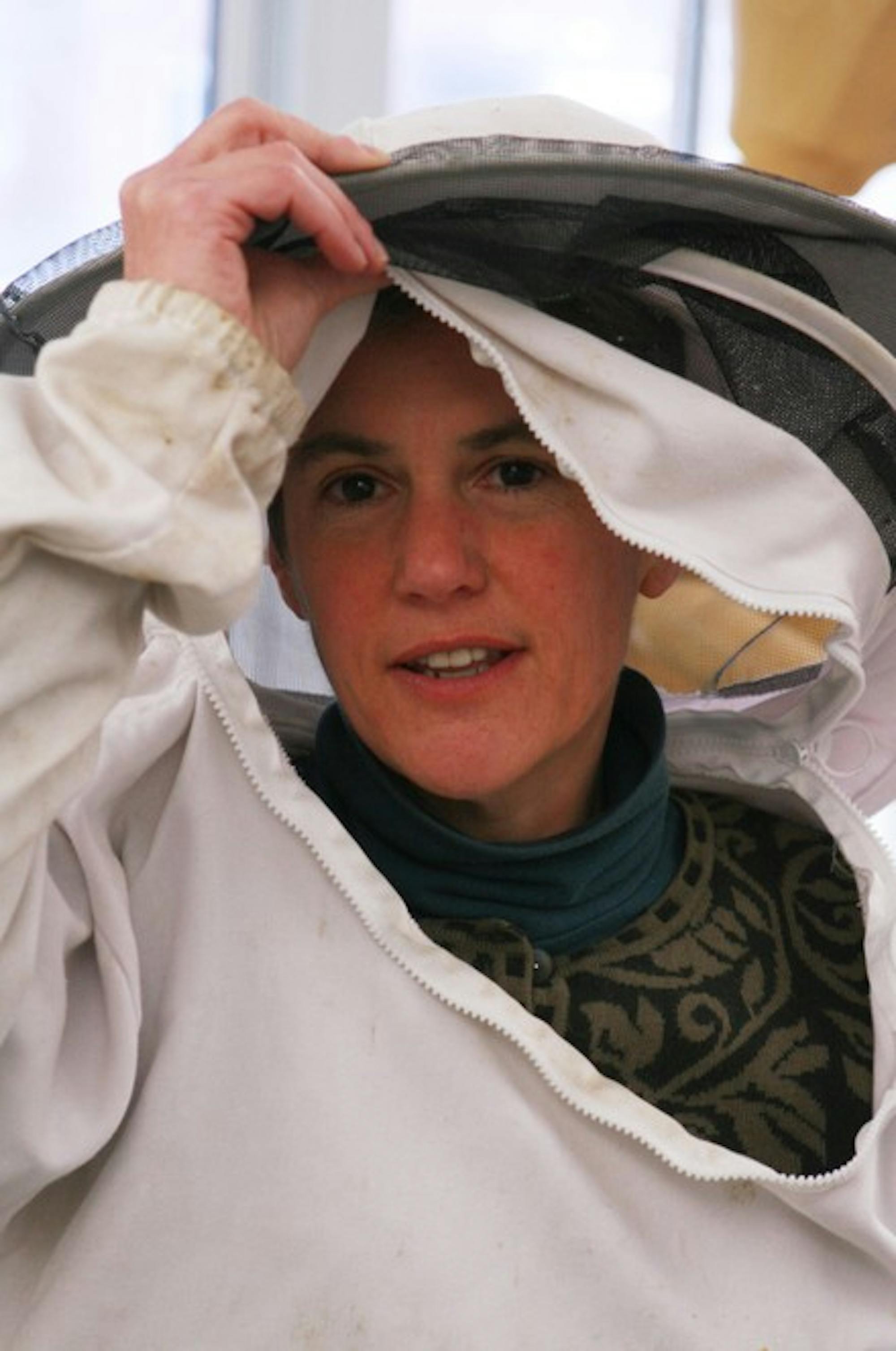 Computer science professor Lorie Loeb acts as a beekeeper in the 270-acre sustainable living community, Cobb Hill, where she lives.