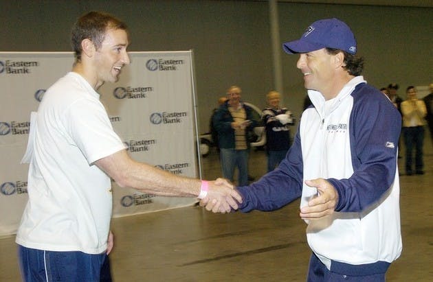 Doug Flutie shook hands with Josh Cushman '03 before the former Dartmouth baseball player's 35-yard drop kick bested Flutie's 30-yard boot.