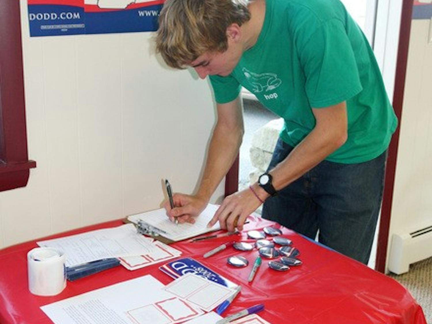 Zach Mayer '08 signs in at the local office opening for presidential hopeful Sen. Chris Dodd, D-Conn., in West Lebanon on Friday, Sept. 21.