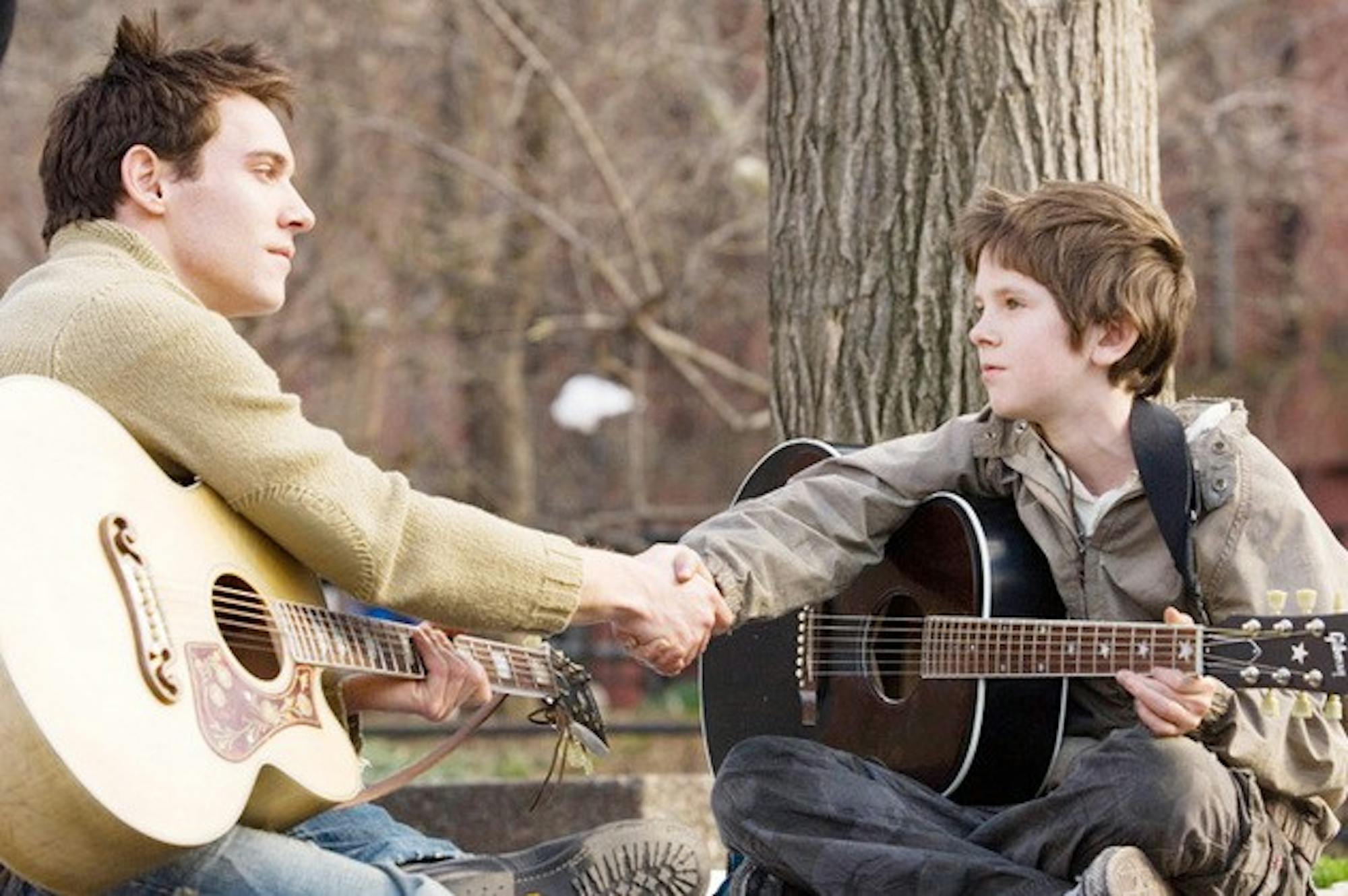 JONATHAN RHYS MEYERS stars as Louis Connelly and FREDDIE HIGHMORE stars as August Rush in Warner Bros. Pictures