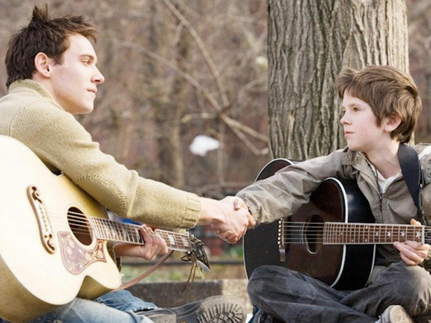 JONATHAN RHYS MEYERS stars as Louis Connelly and FREDDIE HIGHMORE stars as August Rush in Warner Bros. Pictures