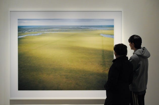 Arvis Sulovari '10 and Reyna Ramirez '10 look at a Subhankar Banerjee photograph in the Jaffe-Friede Gallery. Banerjee's work focuses on the terrain and indigenous peoples of the Arctic.