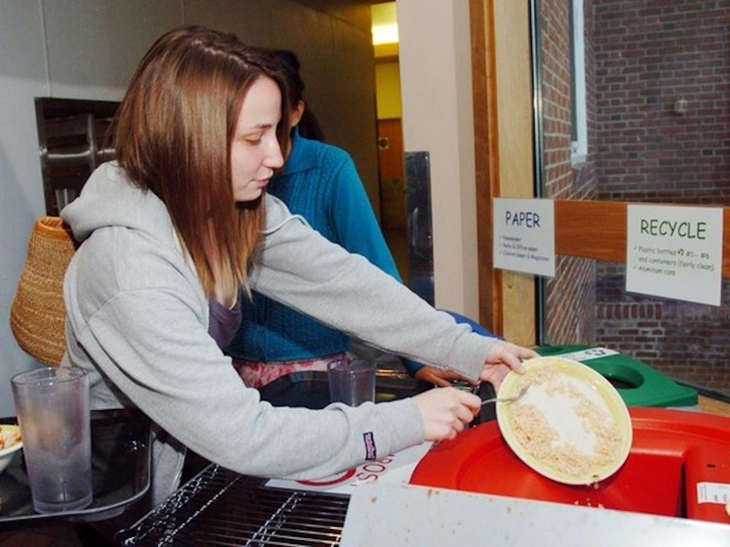 Natalie Spaccarelli '07 contributes to the Home Plate no-waste initiative by scraping her plate clean and following the composting guidelines.