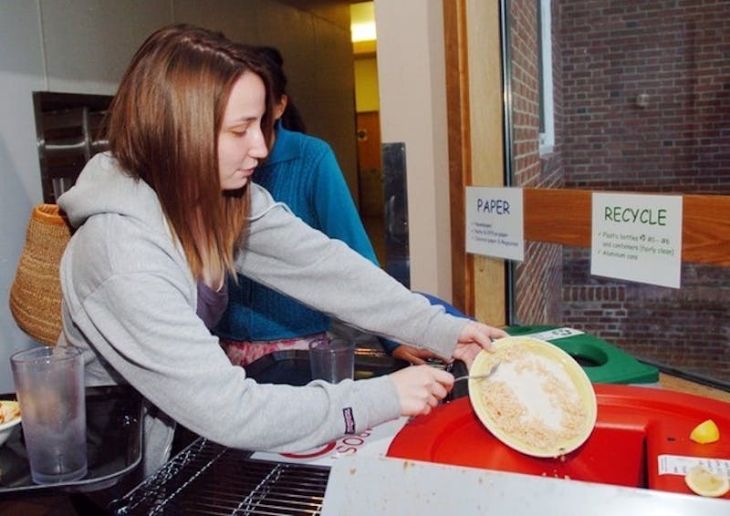 Natalie Spaccarelli '07 contributes to the Home Plate no-waste initiative by scraping her plate clean and following the composting guidelines.