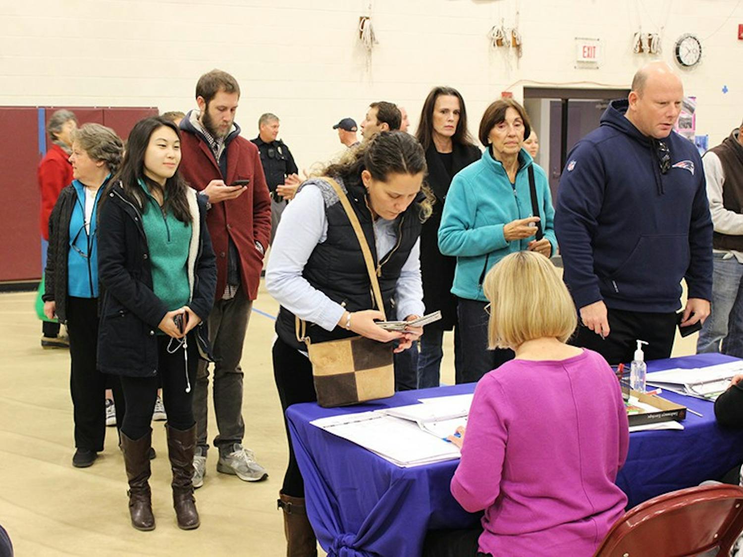 Voters line up to register or sign in before casting their ballots at Hanover High School on Election Day.&nbsp;