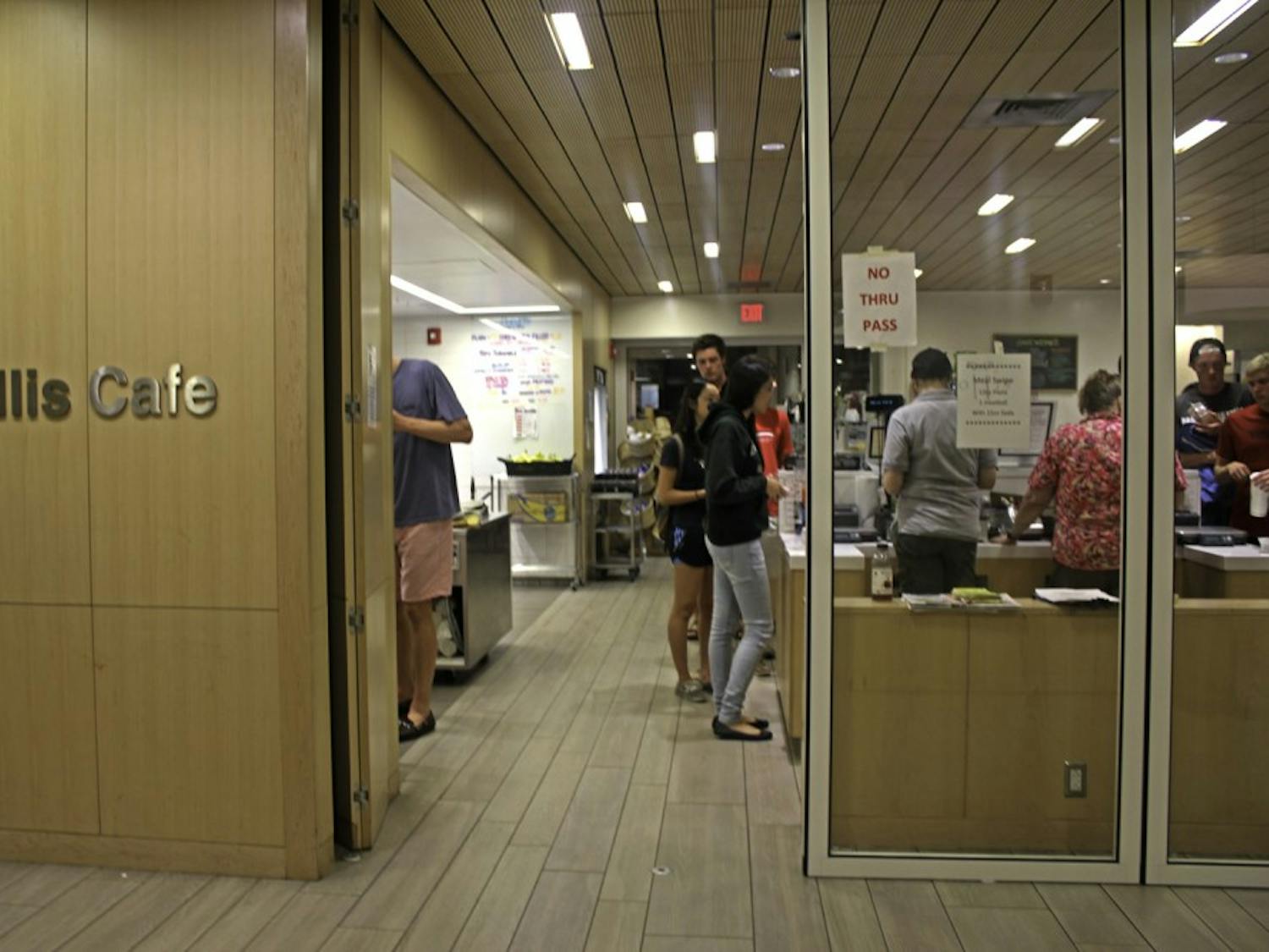 Cashiers keep an eye on students at Collis late night, where entry is now restricted to one side.