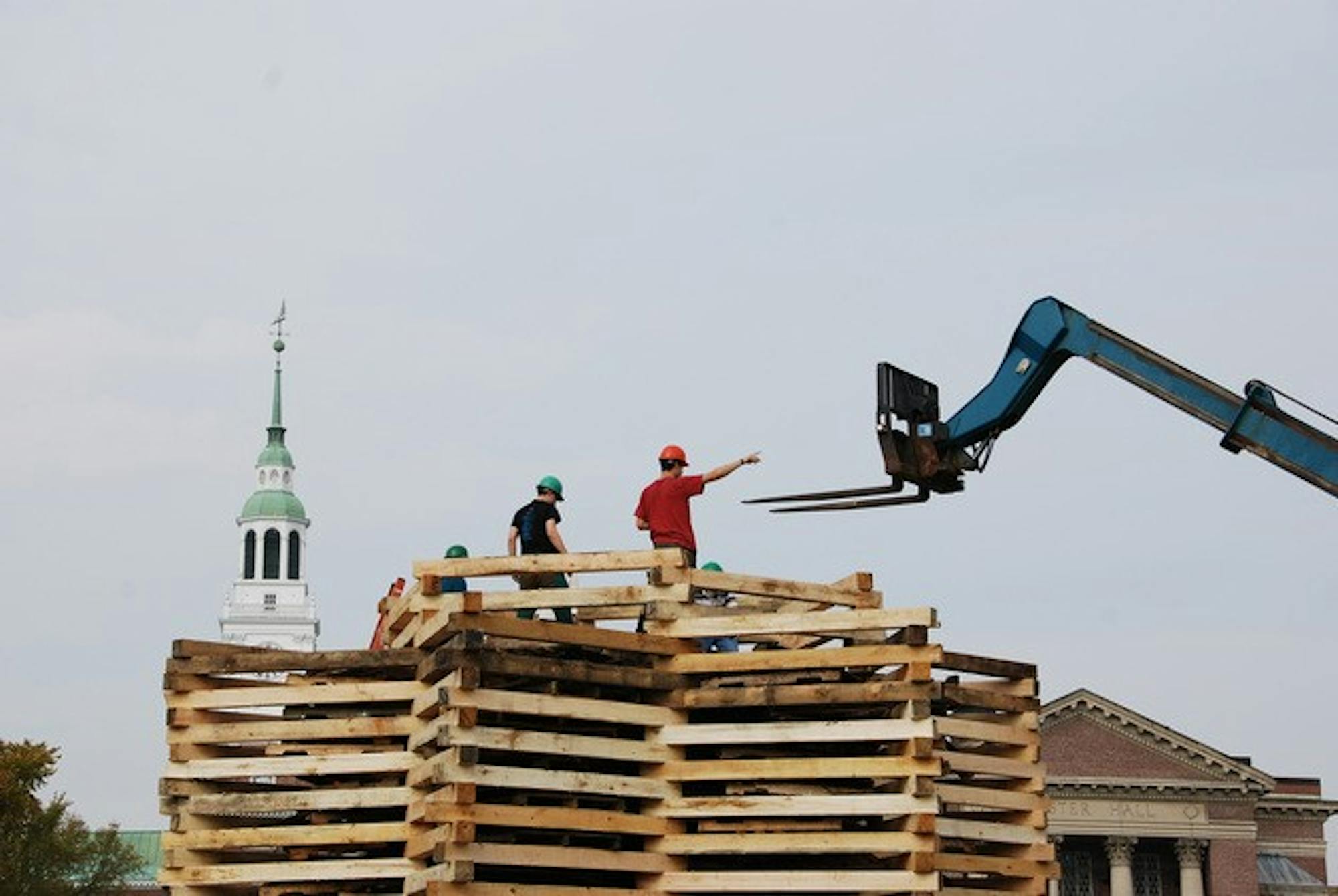 Construction of the bonfire proceeds Thursday afternoon.