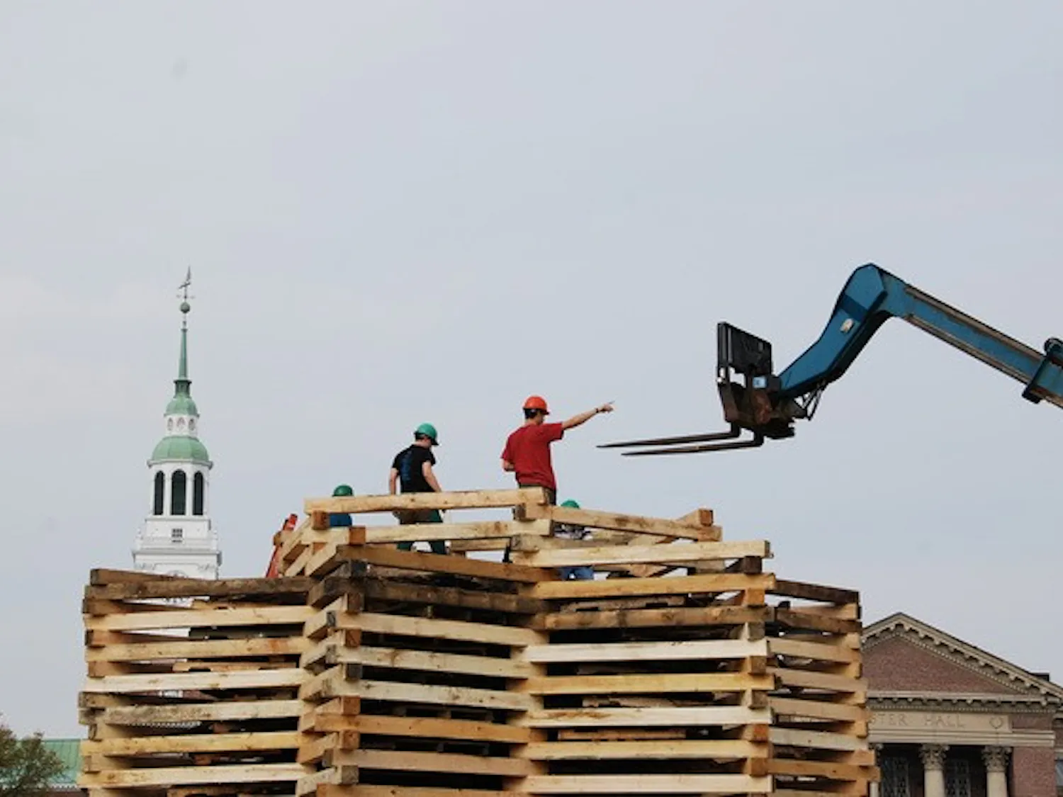 Construction of the bonfire proceeds Thursday afternoon.