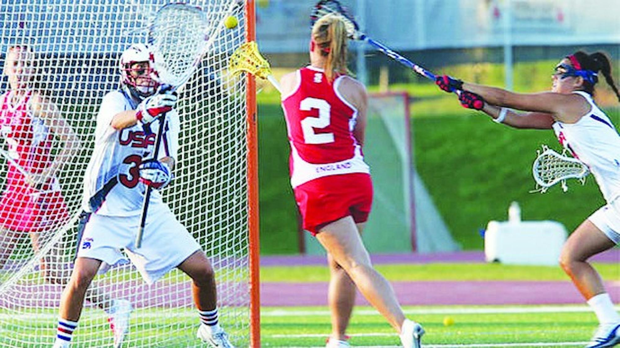 Devon Wills '06 defends the U.S. team's cage during the 2013 women's lacrosse World Cup. Julia Szafman '13 goal tended for team Israel.