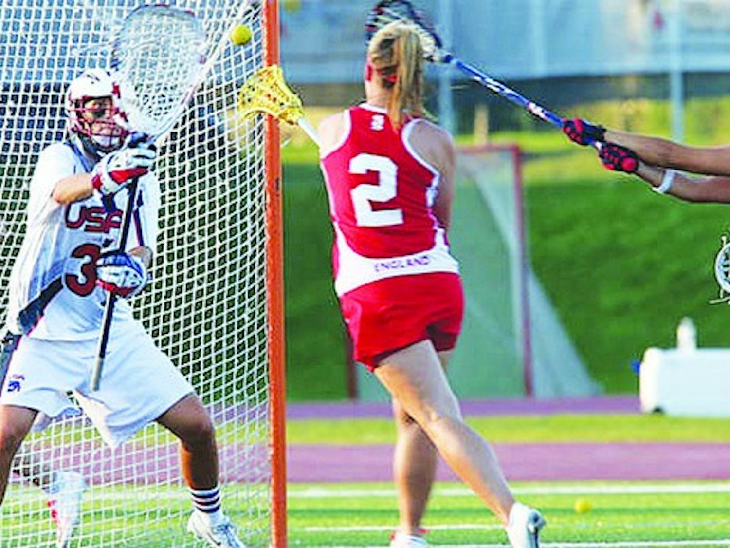 Devon Wills '06 defends the U.S. team's cage during the 2013 women's lacrosse World Cup. Julia Szafman '13 goal tended for team Israel.