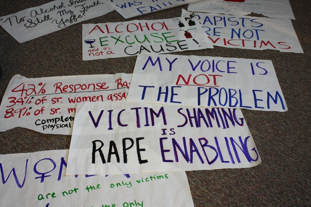 Students held signs with messages for speaker Emily Yoffe as part of a silent protest of her beliefs on rape and culture.