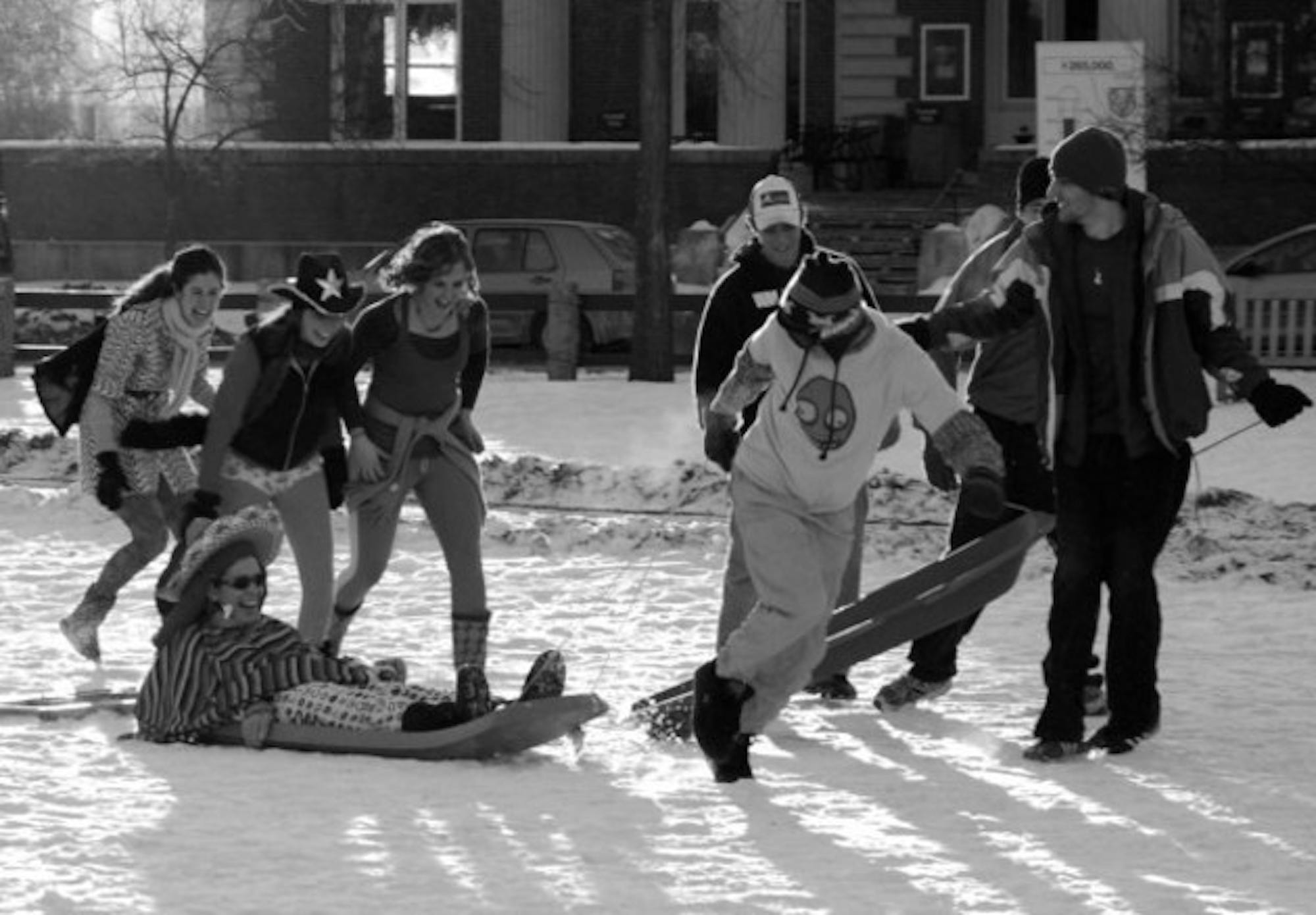 Students dressed in flair competing in the Human Dog Sled race yesterday on the Green at 4 p.m.