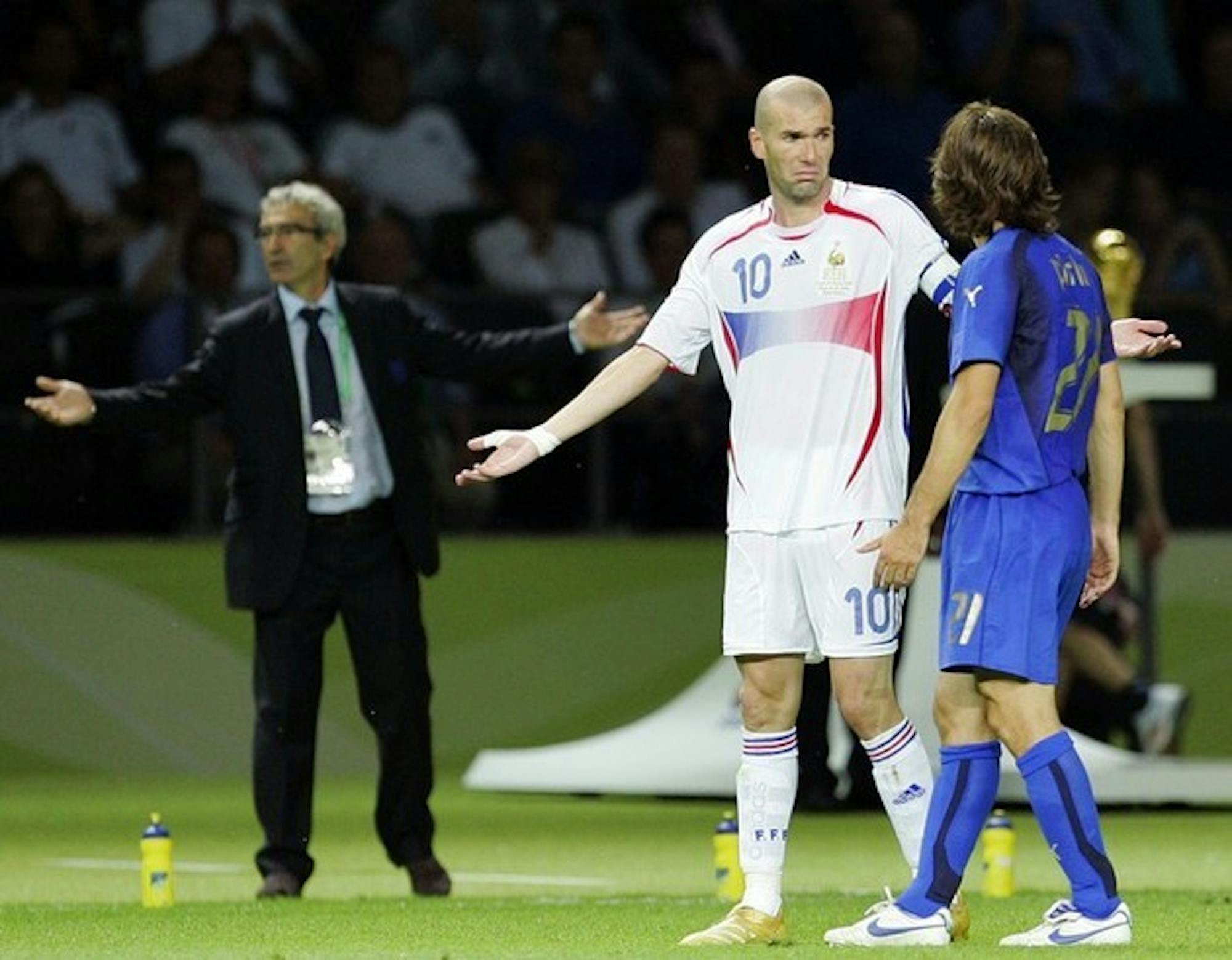 Zidane feigns innocence after his attack on Materazzi while the refereeing team attempts to sort out exactly what had just transpired.Zidane feigns innocence after his attack on Materazzi while the refereeing team attempts to sort out exactly what had just transpired.
