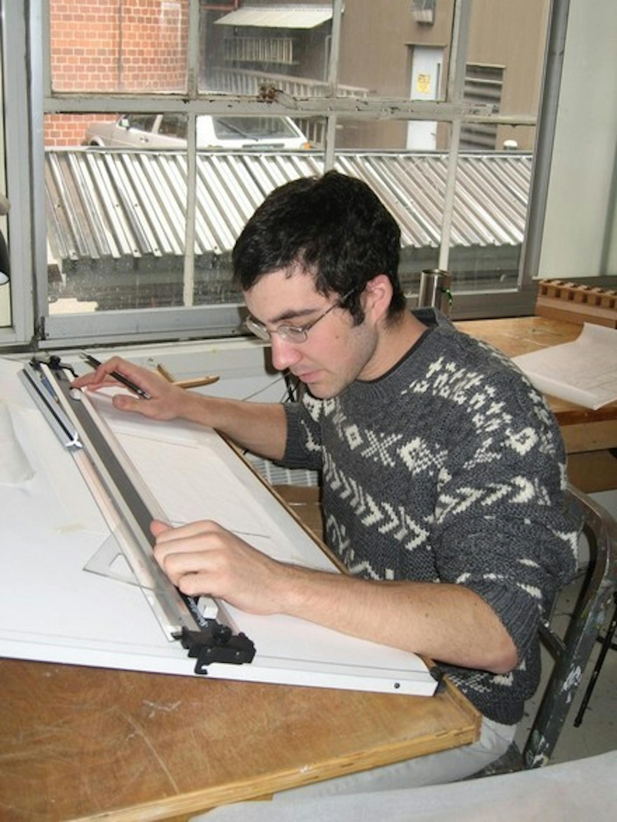 Tom Bonamici '07 demonstrates his drafting talents in the architecture studio. Bonamici is currently redesigning a workshop for Cabin and Trail as an independent study in the studio art department.