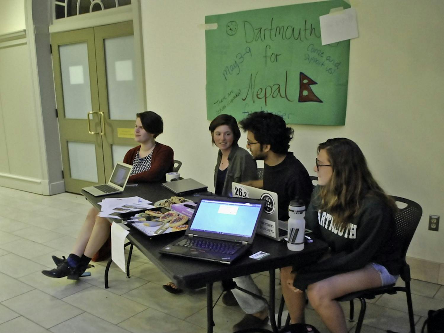 Students sit outside the Paganucci Lounge in the Class of 1953 Commons to raise awareness and funds for Nepal.