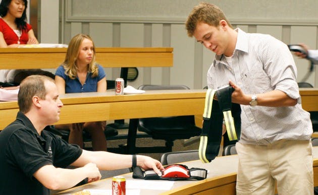 Michal Jablonski '09 demonstrates his four-member student group's product, the Nightrunner, at this year's Big Green Business Competition Thursday.