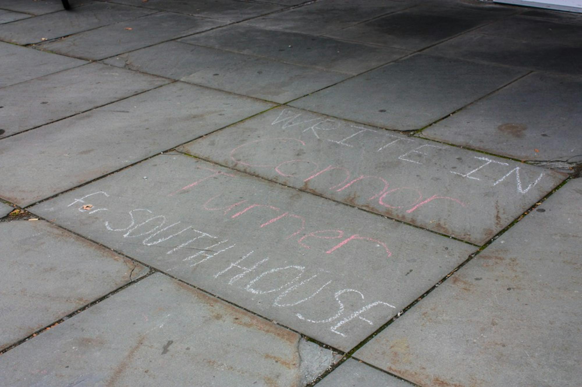Students wrote campaign messages in chalk outside South House.