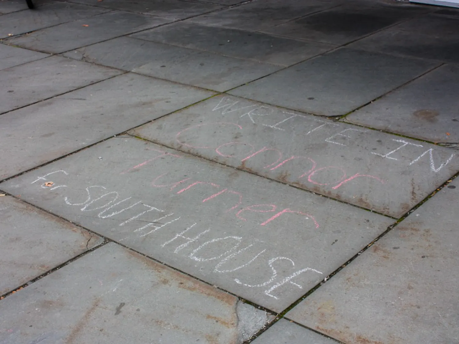 Students wrote campaign messages in chalk outside South House.