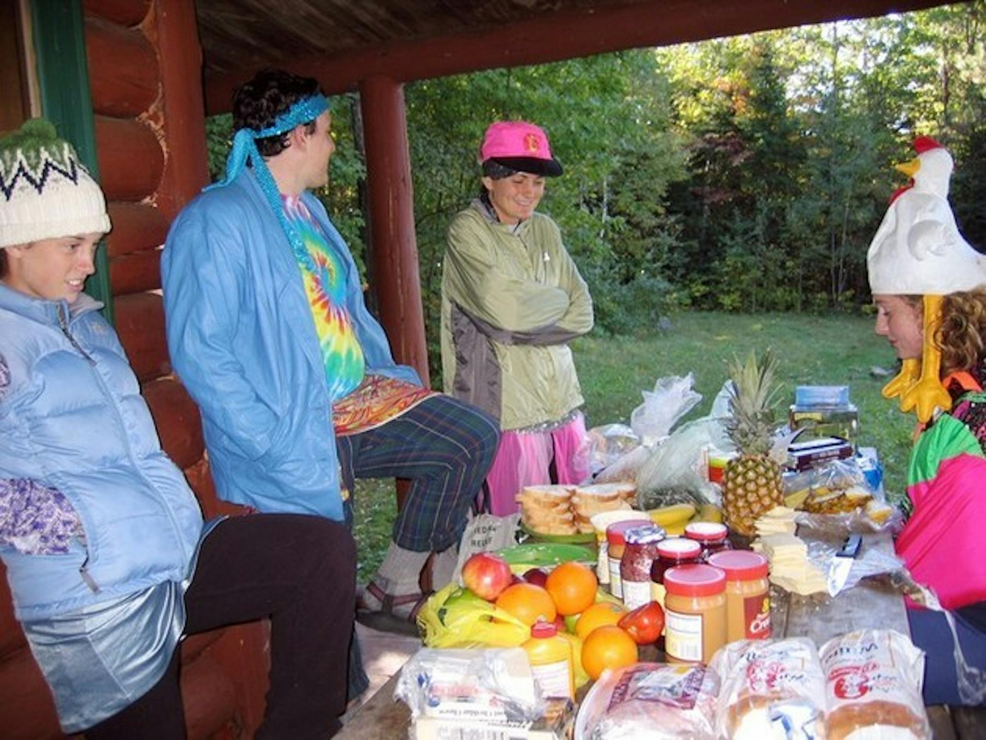 Several support station volunteers wait for fall hikers to make it to Great Bear Cabin, the final stop on way to Moosilauke. The volunteers provide much needed entertainment and good cheer along with food and water.