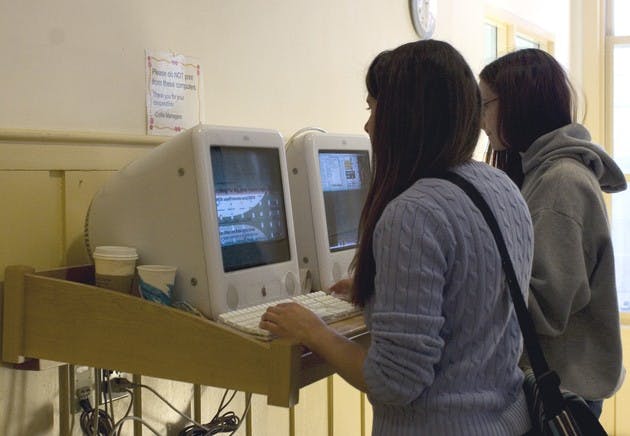 Lauren Caracciola '09 and Mckenzie Howell '10 use BlitzMail terminals in Collis. Student Assembly handed off maintenance to Computing Services.