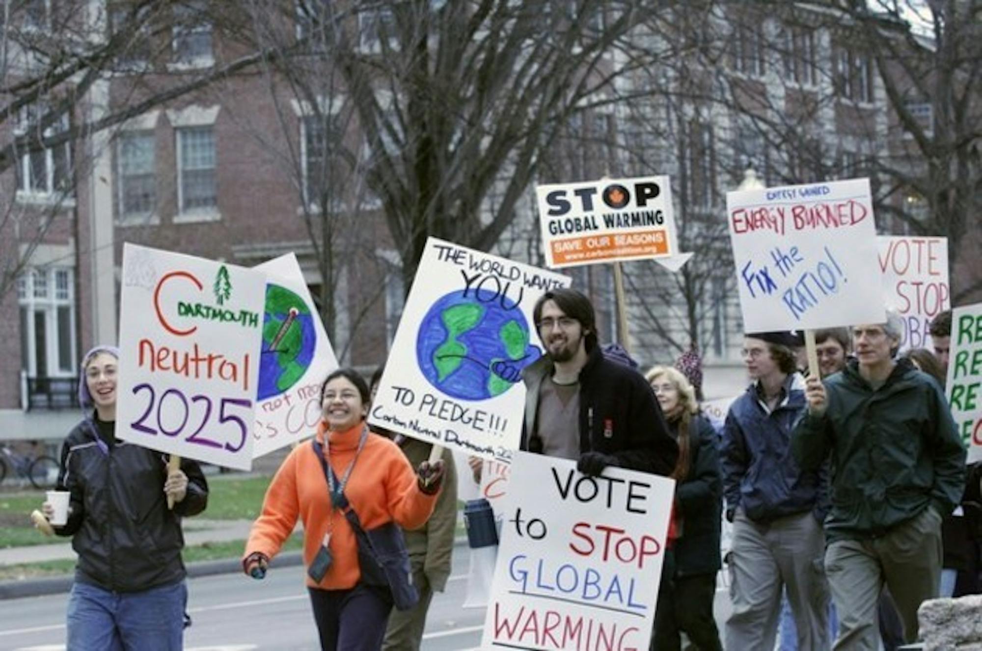 Students and town residents march on East Wheelock Street to raise awareness about global warming.